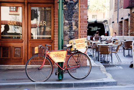 Image copyright Deuce Design. Project: The Rocks Market. The Rocks Market cycle signage is a gorilla marketing approach to integrate site-specific wayfinding and directional signage into an historic precinct. Deuce Design sourced a variety of vintage bikes, restoring and creating hand-painted signage to complete the picture.
